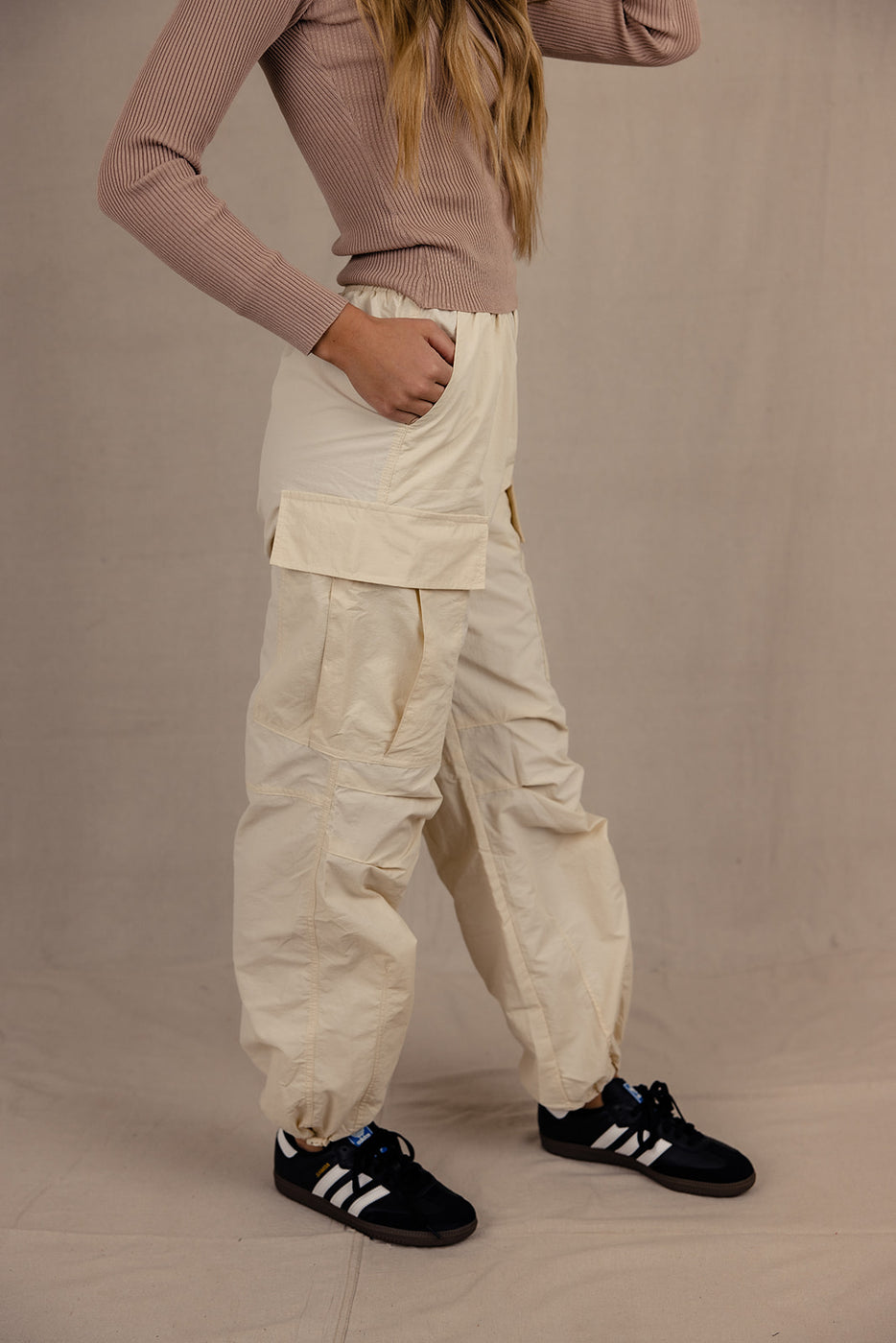 a woman wearing a beige pants