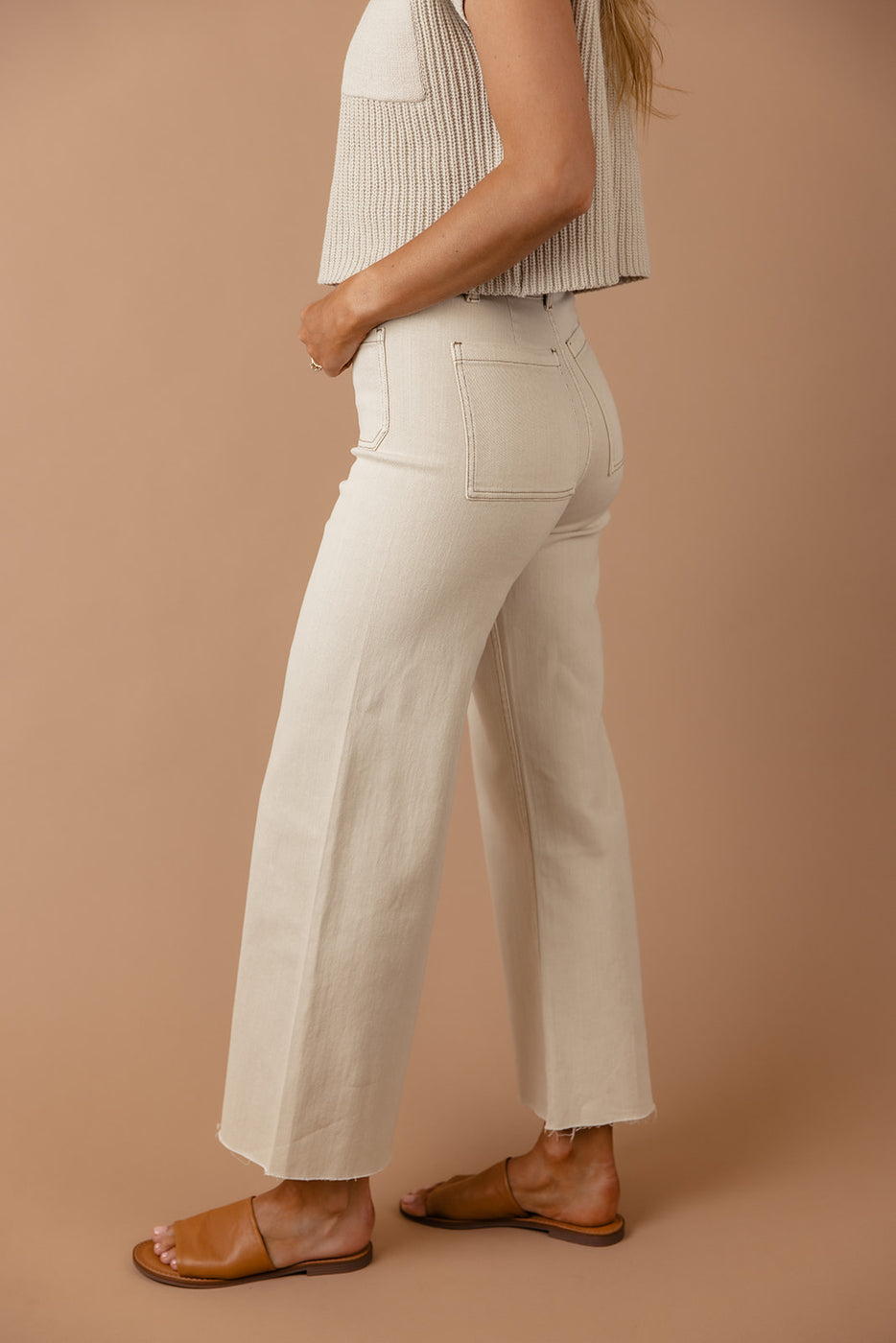 a woman wearing a white pants