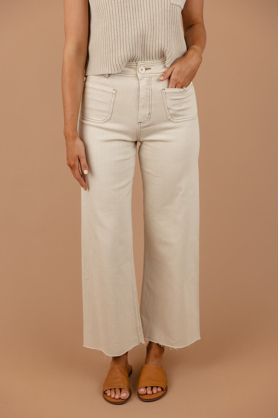 a woman wearing white pants