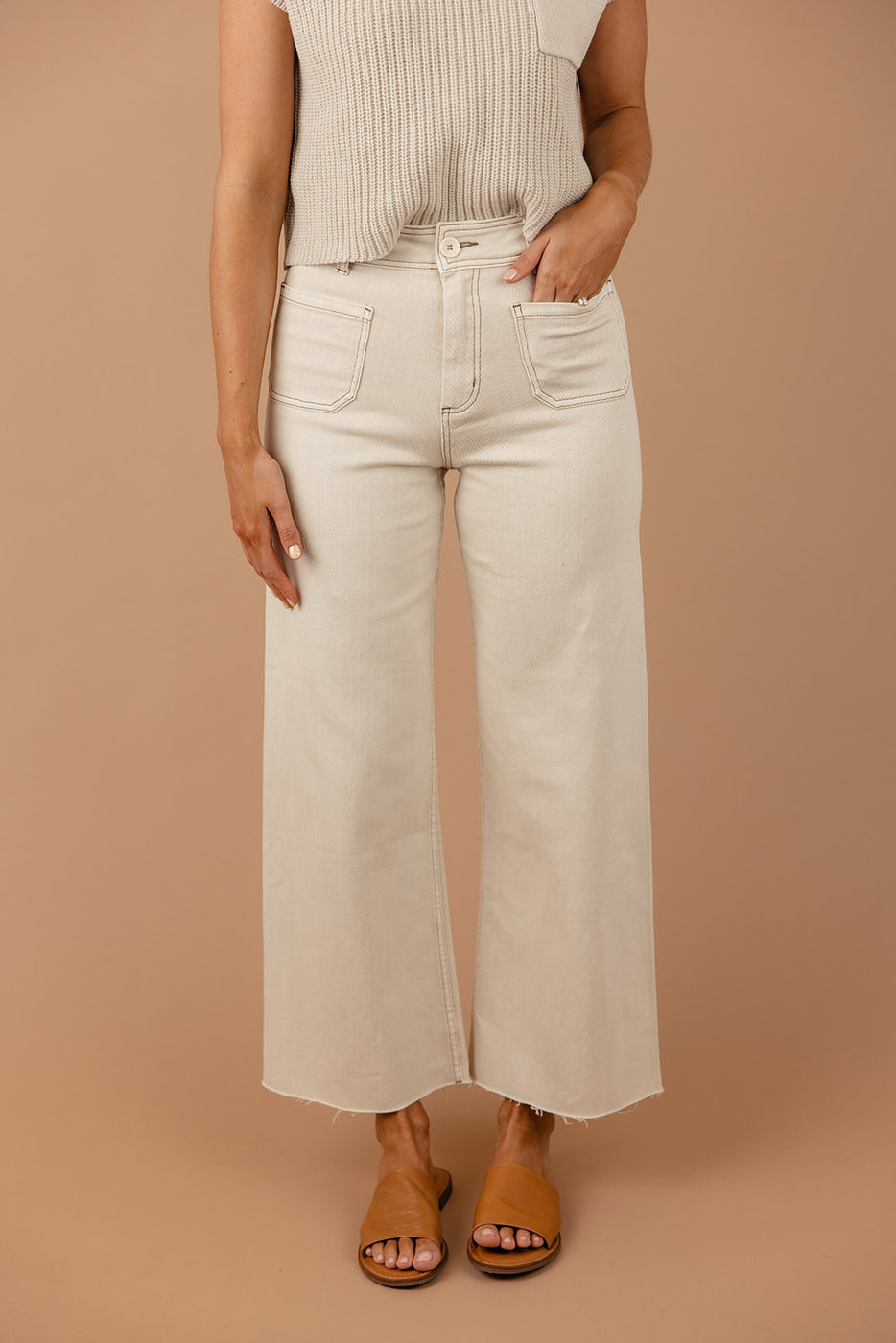 a woman wearing white pants