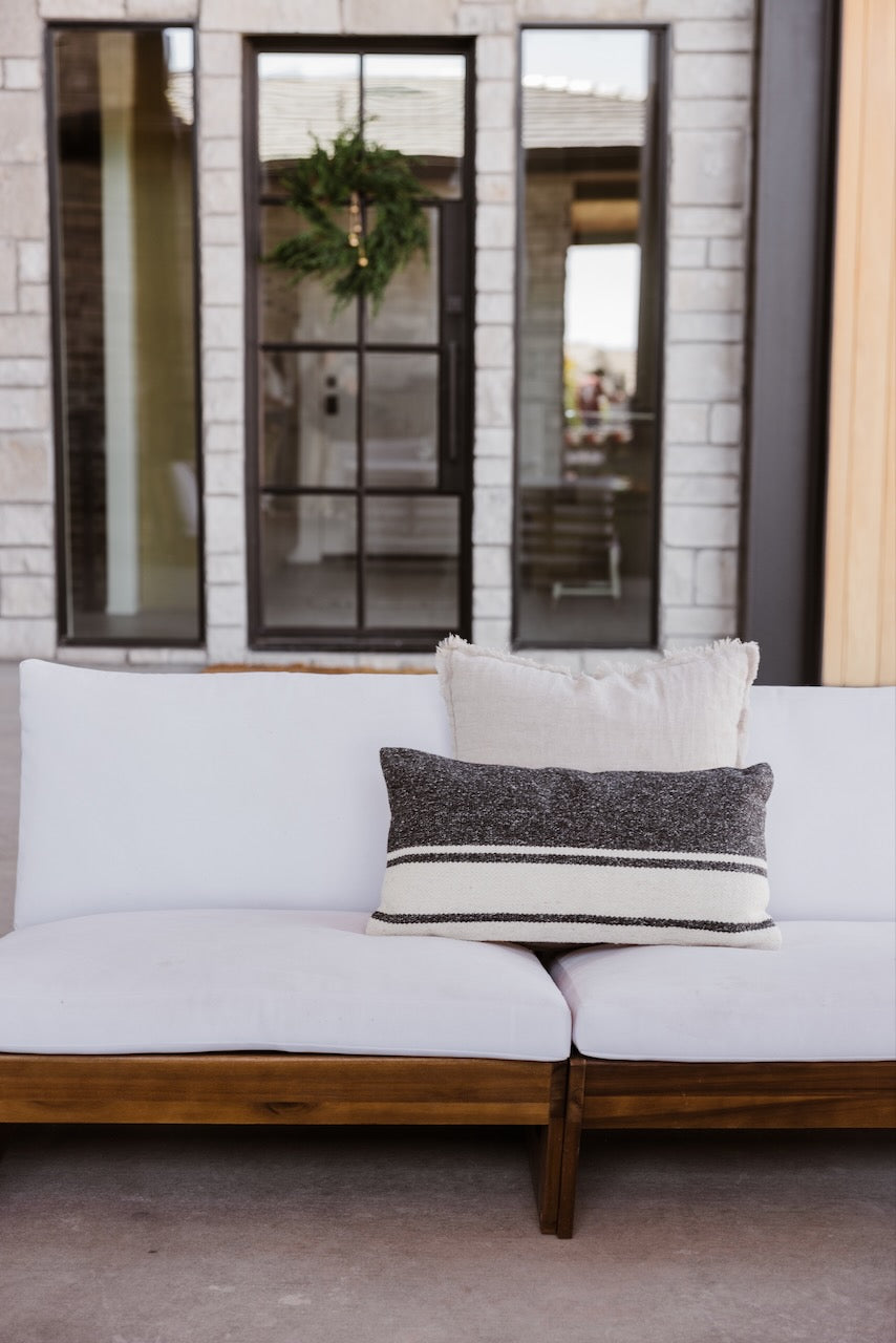 a white couch with pillows on it