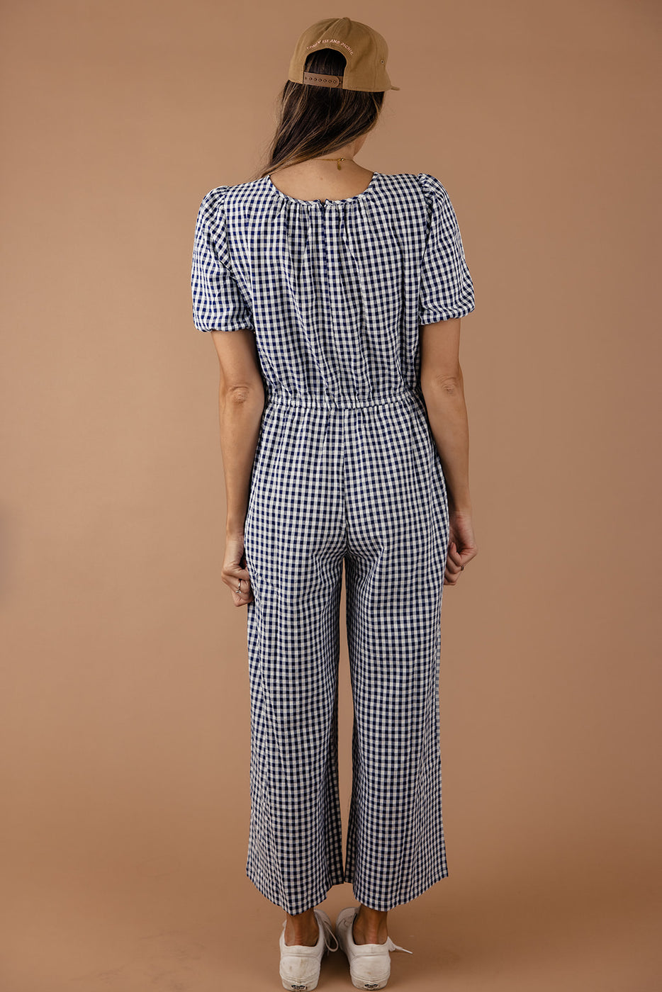 a woman in a blue and white checked jumpsuit