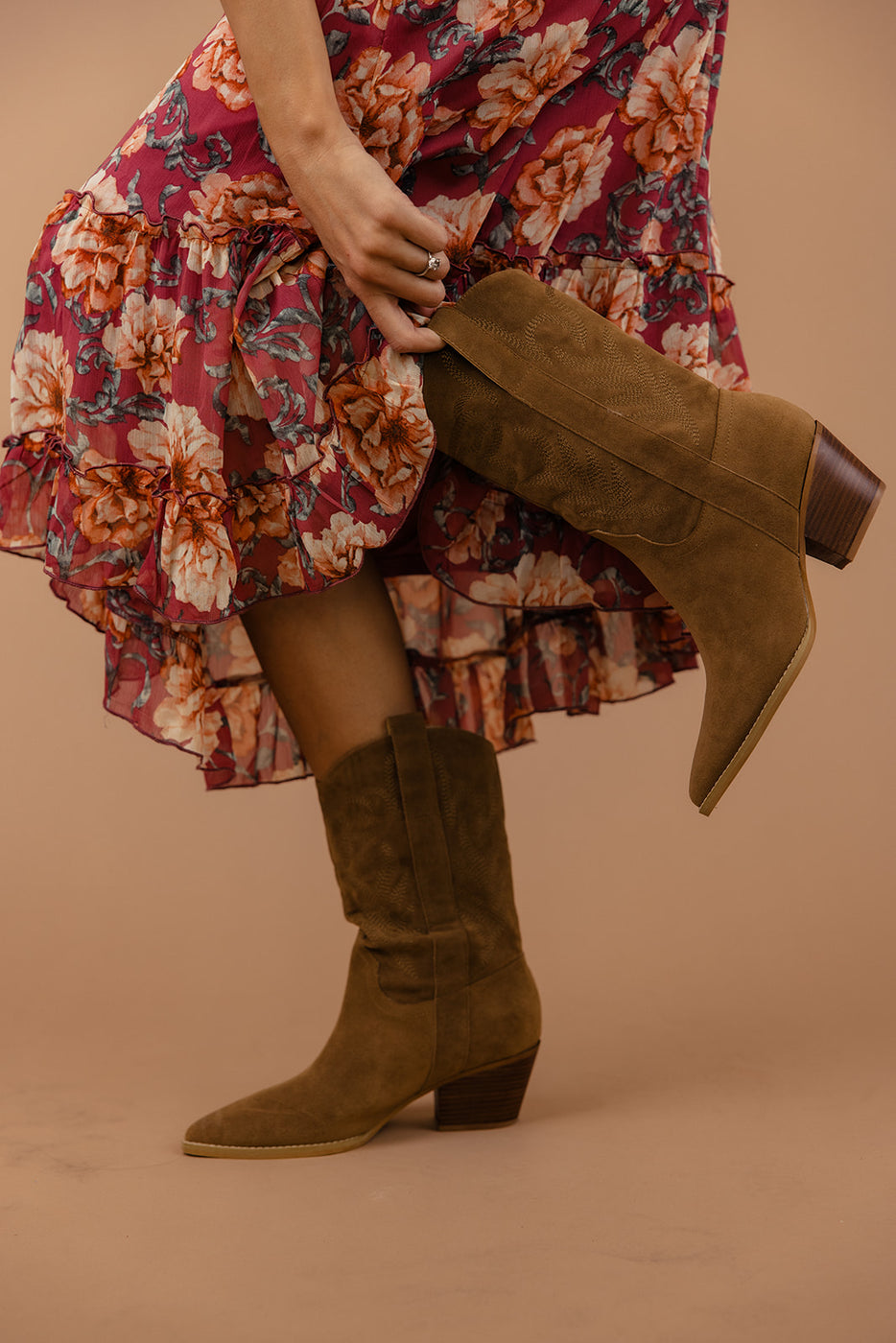 a person wearing a dress and boots
