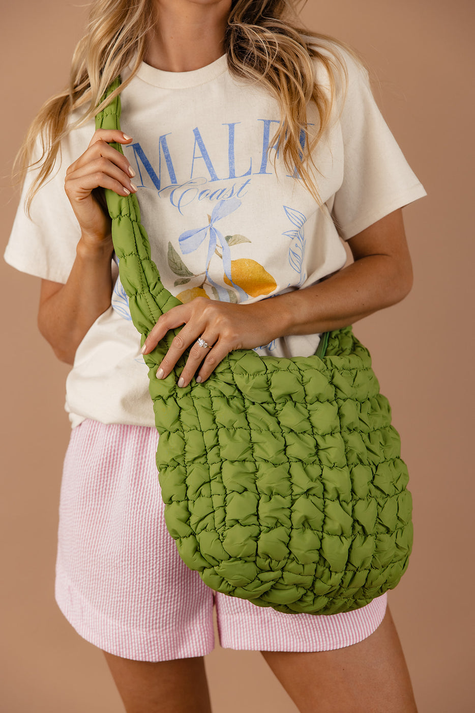 a woman holding a green bag