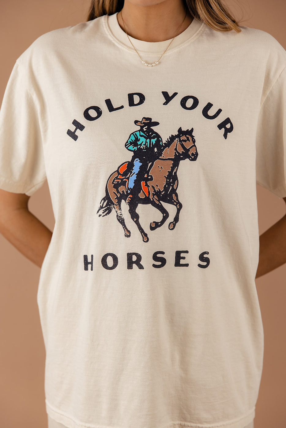 a person wearing a white shirt with a cowboy on a horse