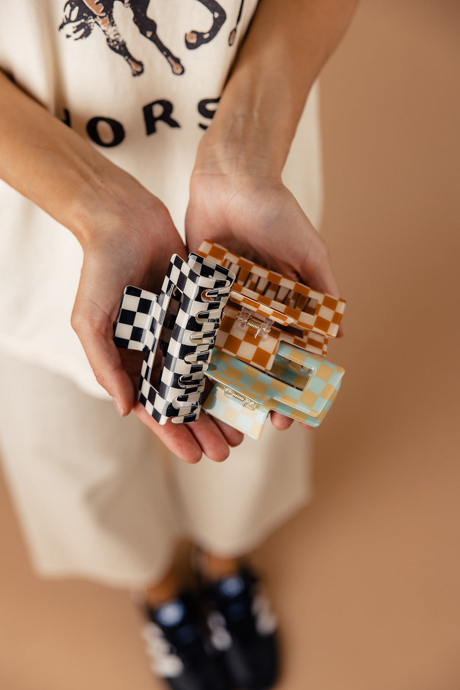 a person holding small checkered clips
