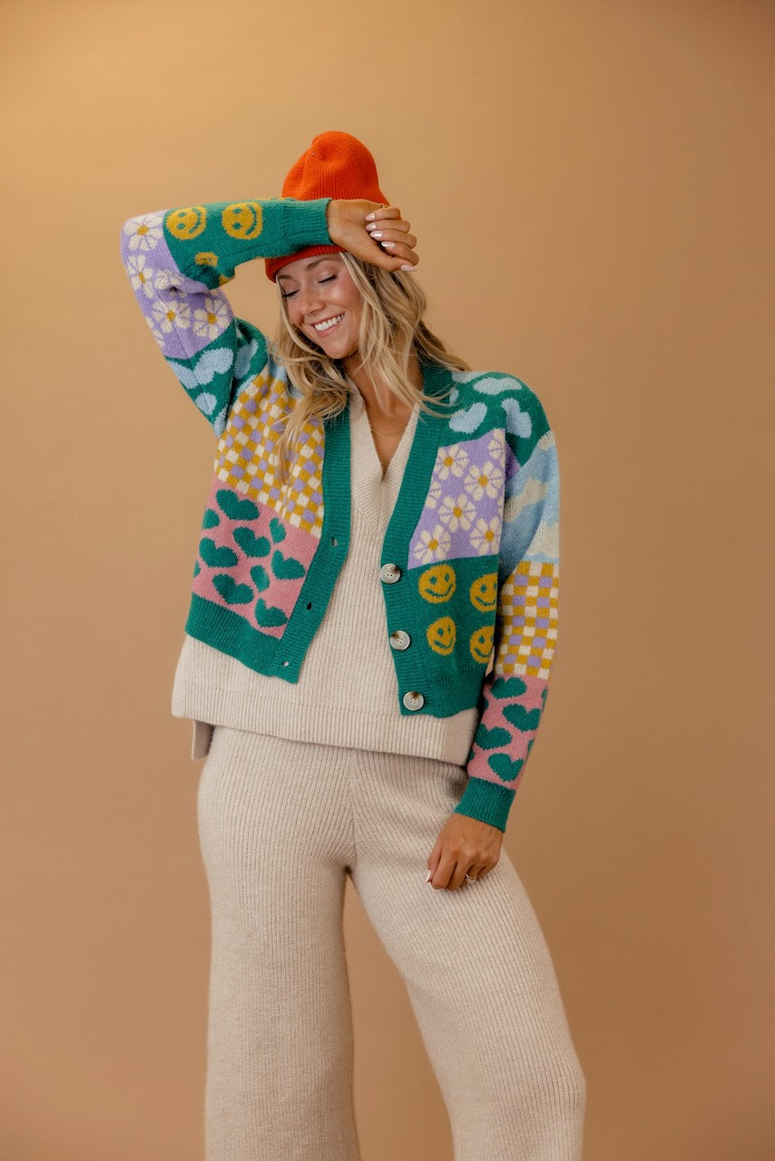 a woman wearing a colorful sweater and hat