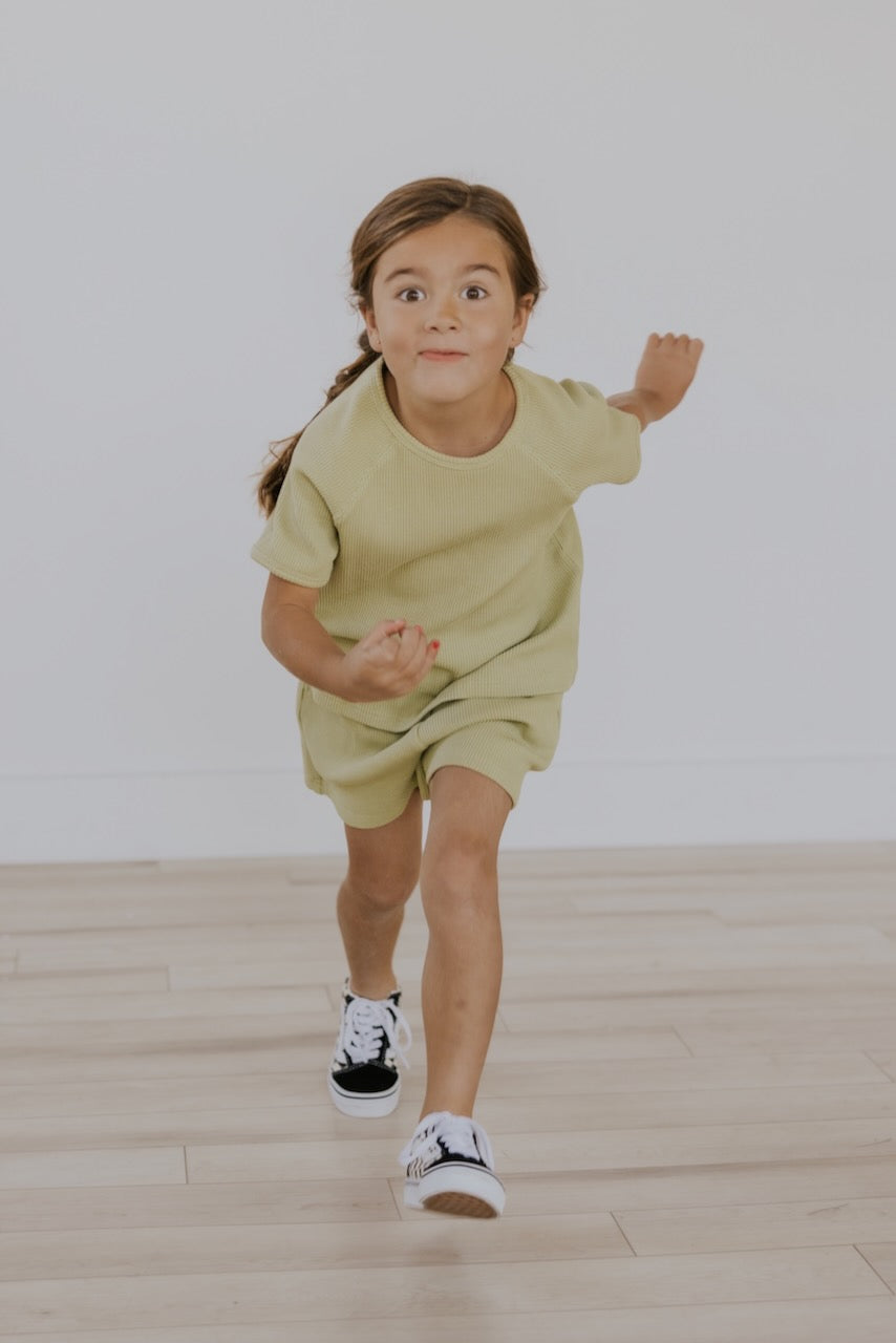 a girl running with her hand up