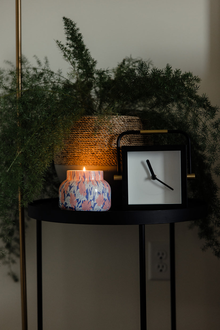 a clock and a candle on a table