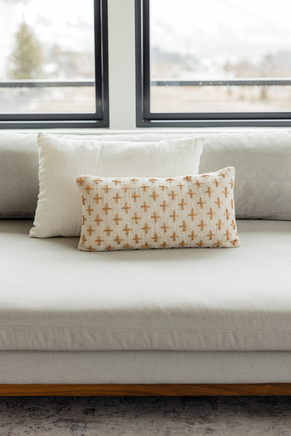 a white couch with pillows on it