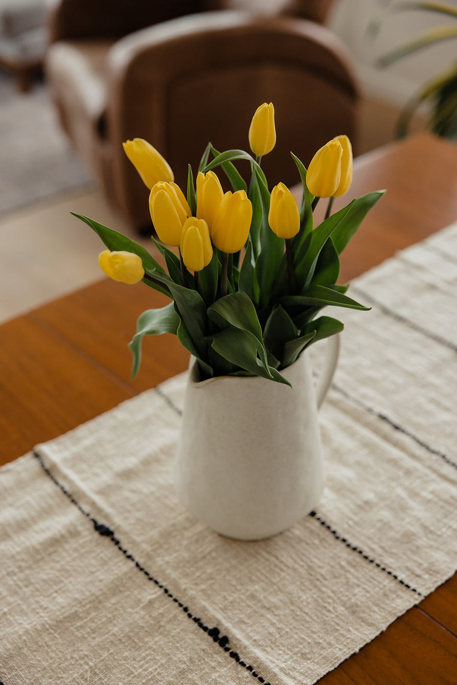 a vase of yellow tulips