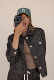 Person holding a camera with a neutral background