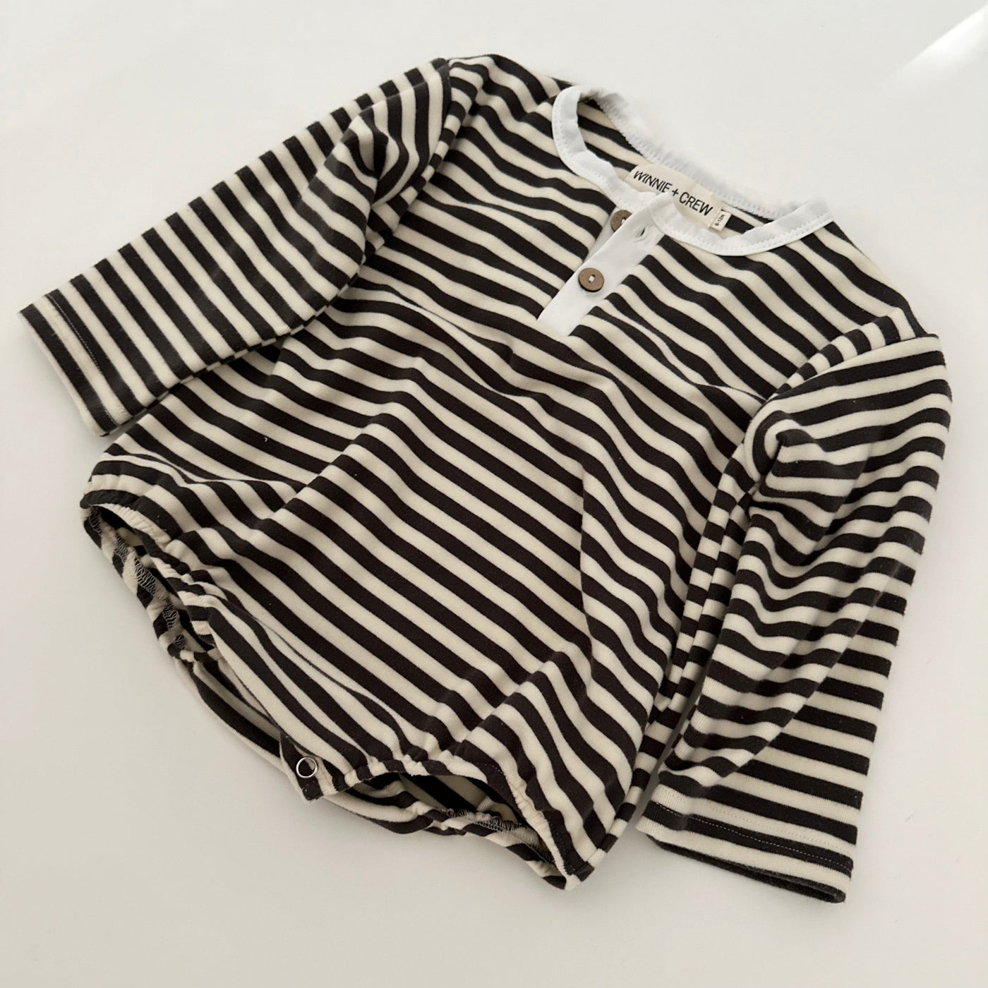 a striped shirt on a white surface