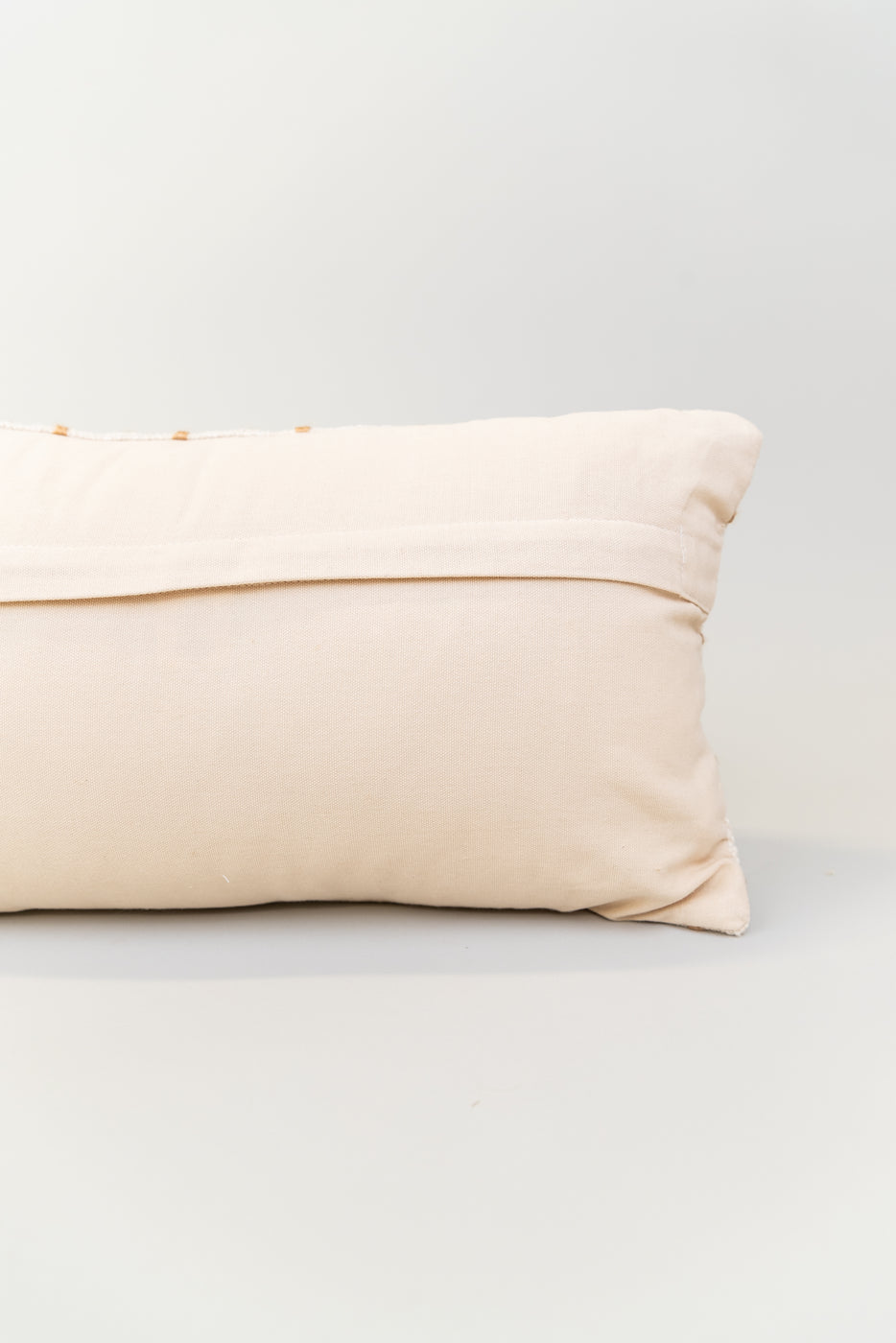 a white pillow on a white surface