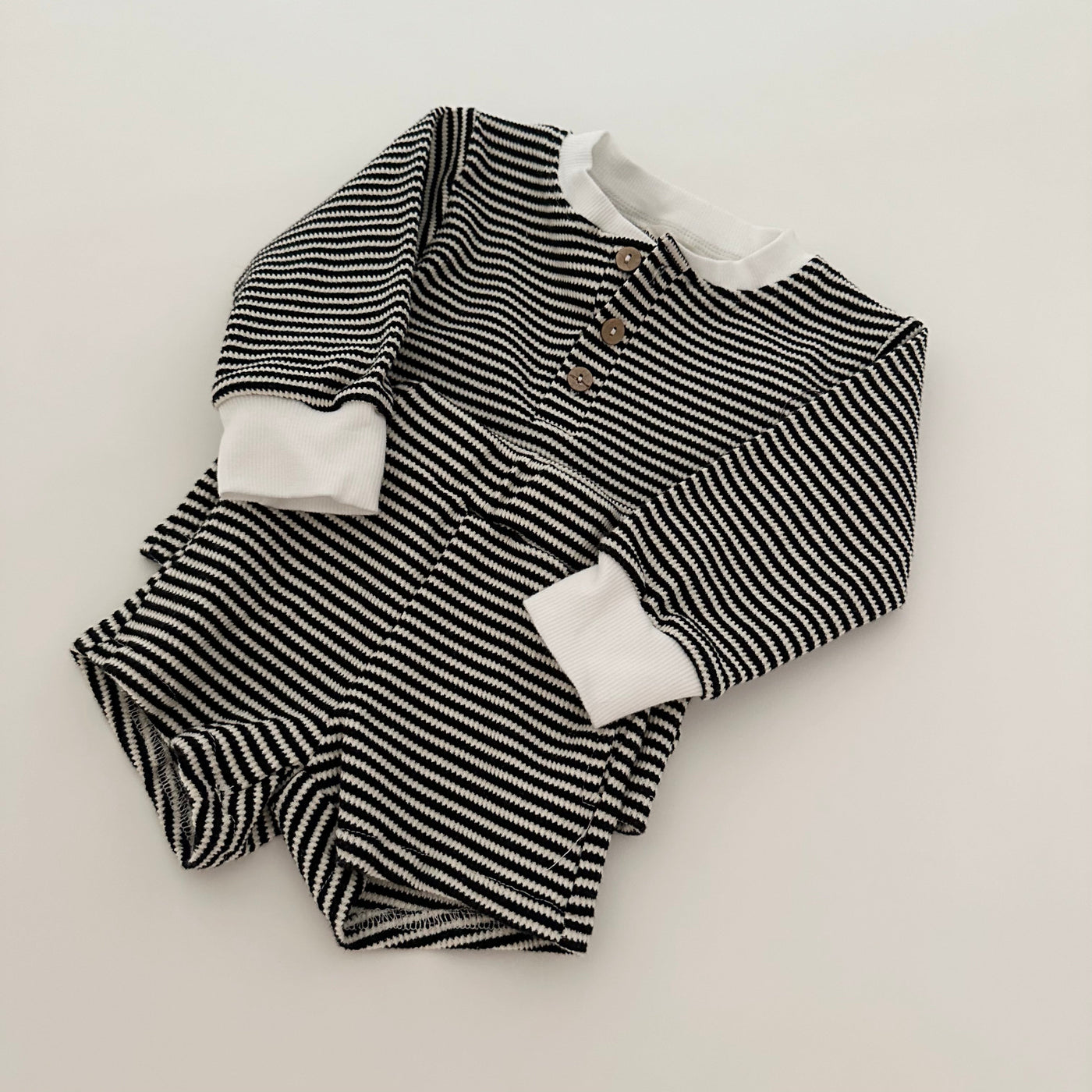 a striped outfit on a white surface