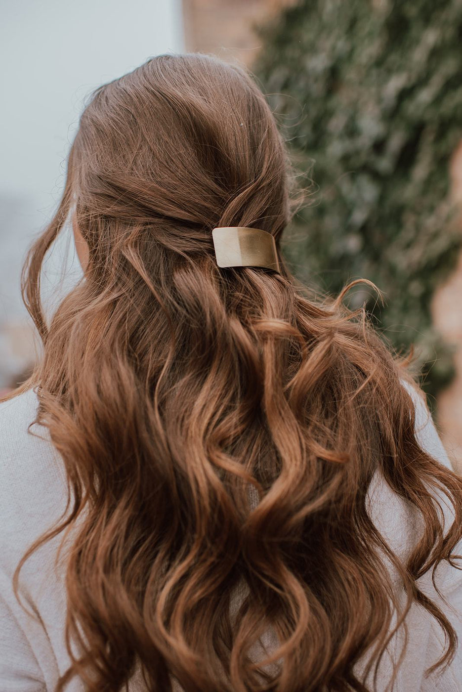 a woman with a gold hair clip