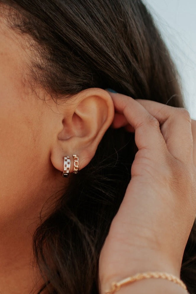 a person's ear with earrings
