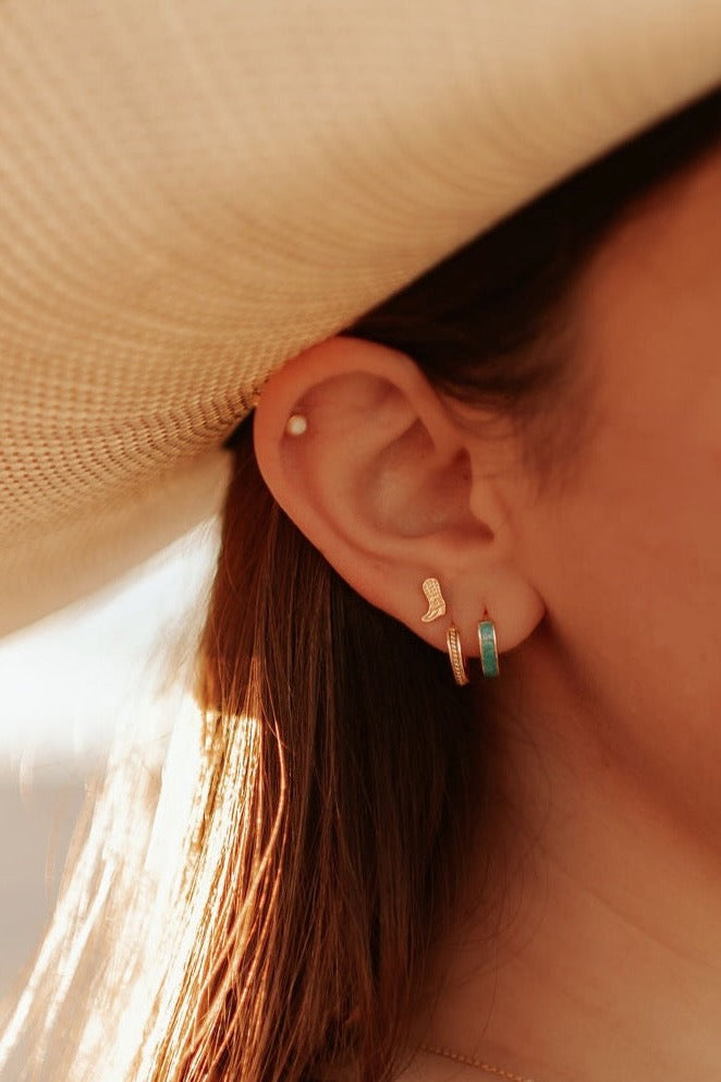 a person wearing a hat and earring