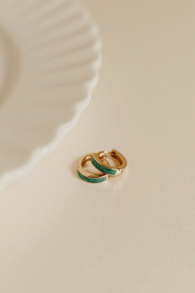 a pair of earrings on a white plate