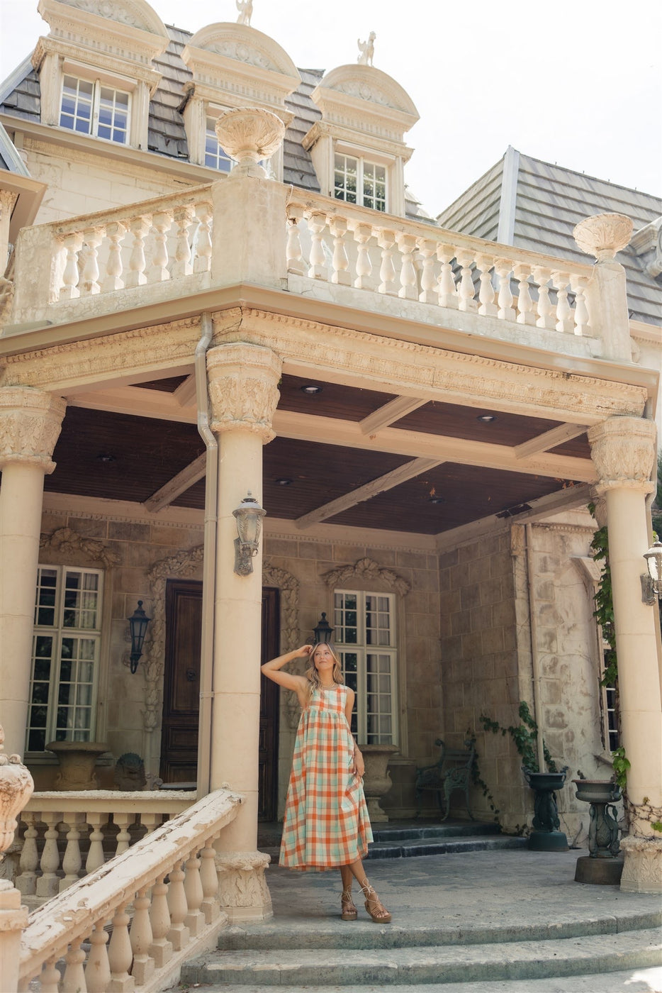 a woman standing in front of a house