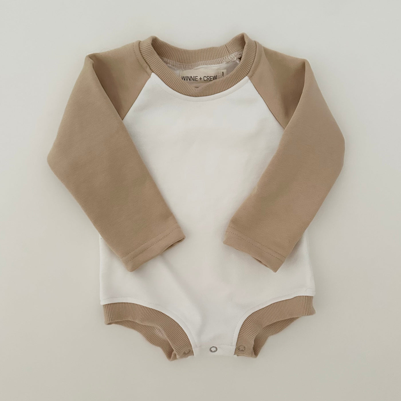 a baby bodysuit on a white background