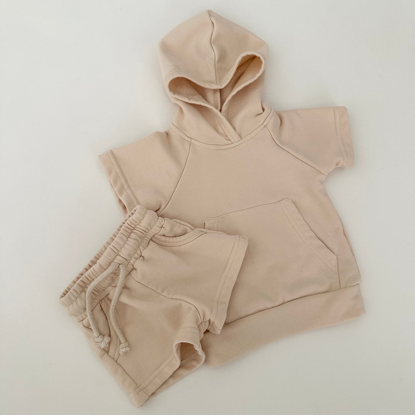 a beige hoodie and shorts