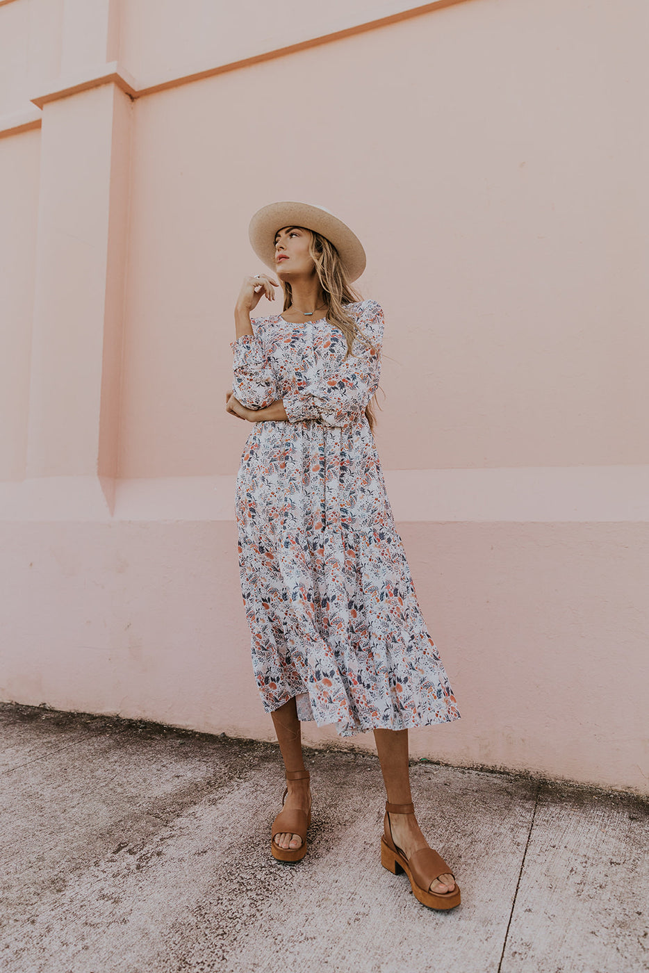 a woman in a dress and hat