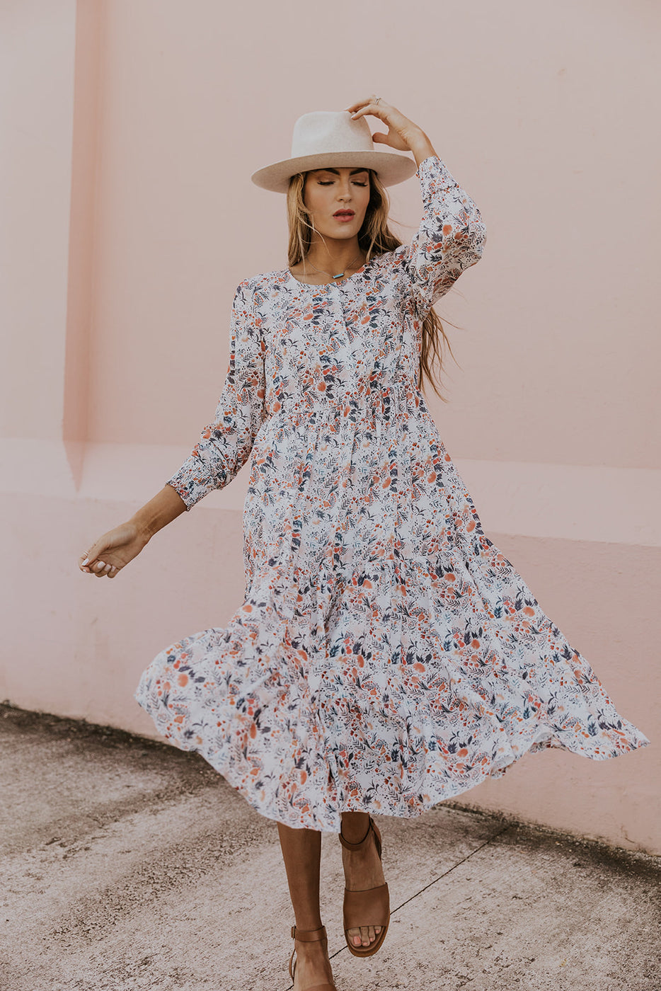 a woman wearing a dress and hat