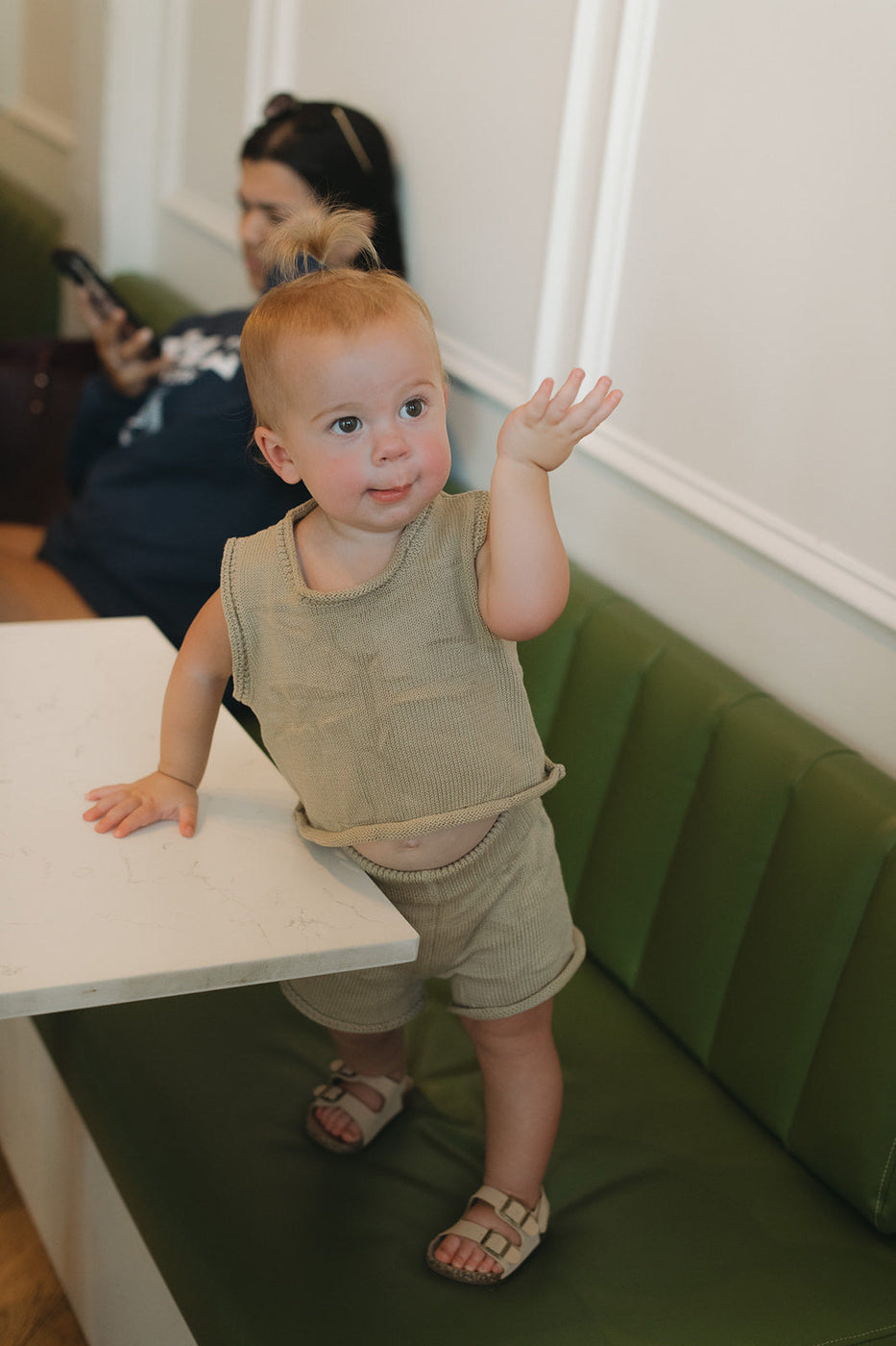 a baby standing on a table