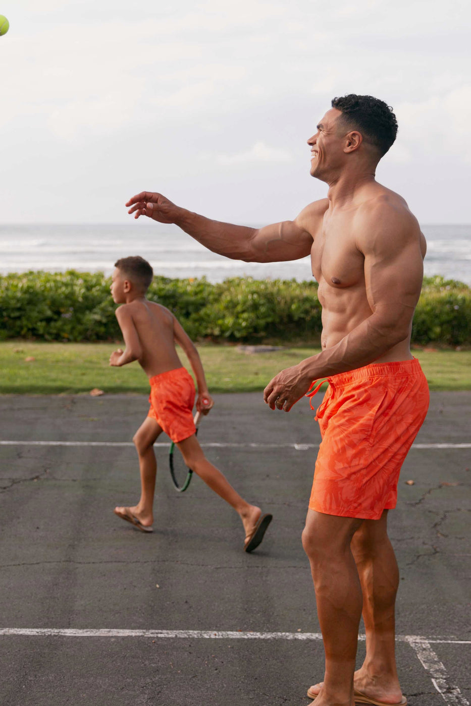 a man and boy in orange shorts