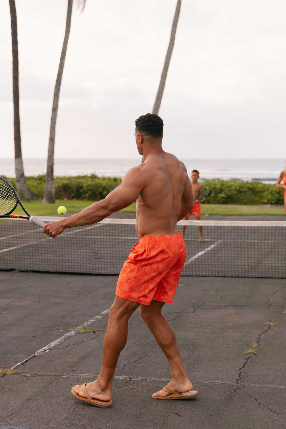 a man holding a tennis racket and ball