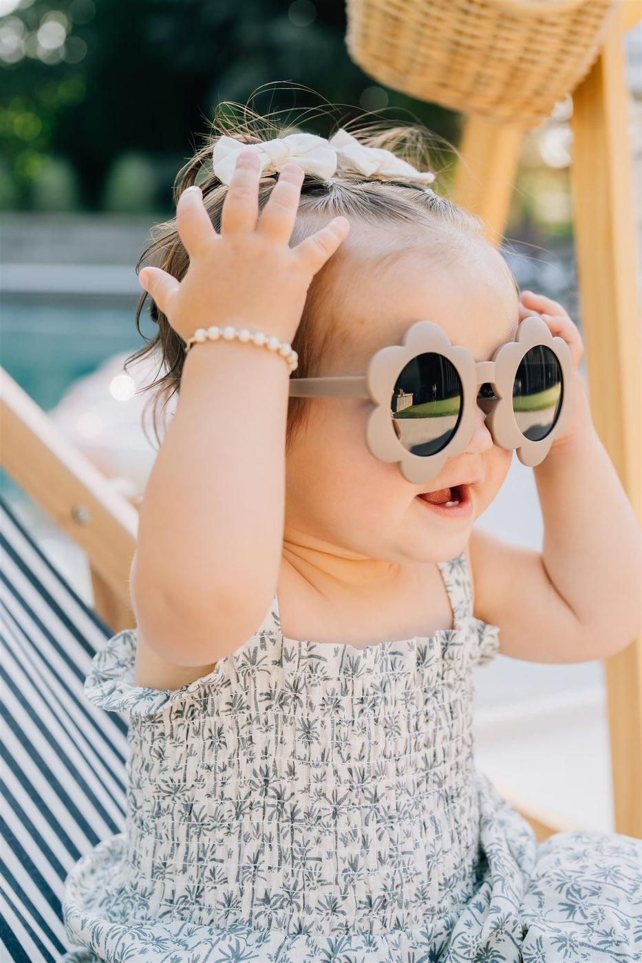 a baby wearing sunglasses and a flower shaped sunglasses