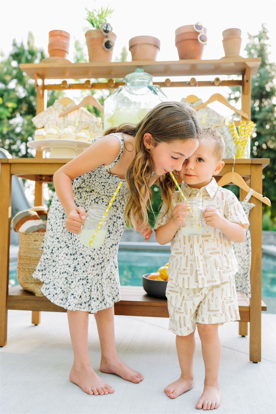 a two children drinking from a straw