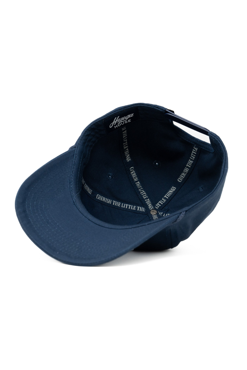 a blue baseball cap with white text