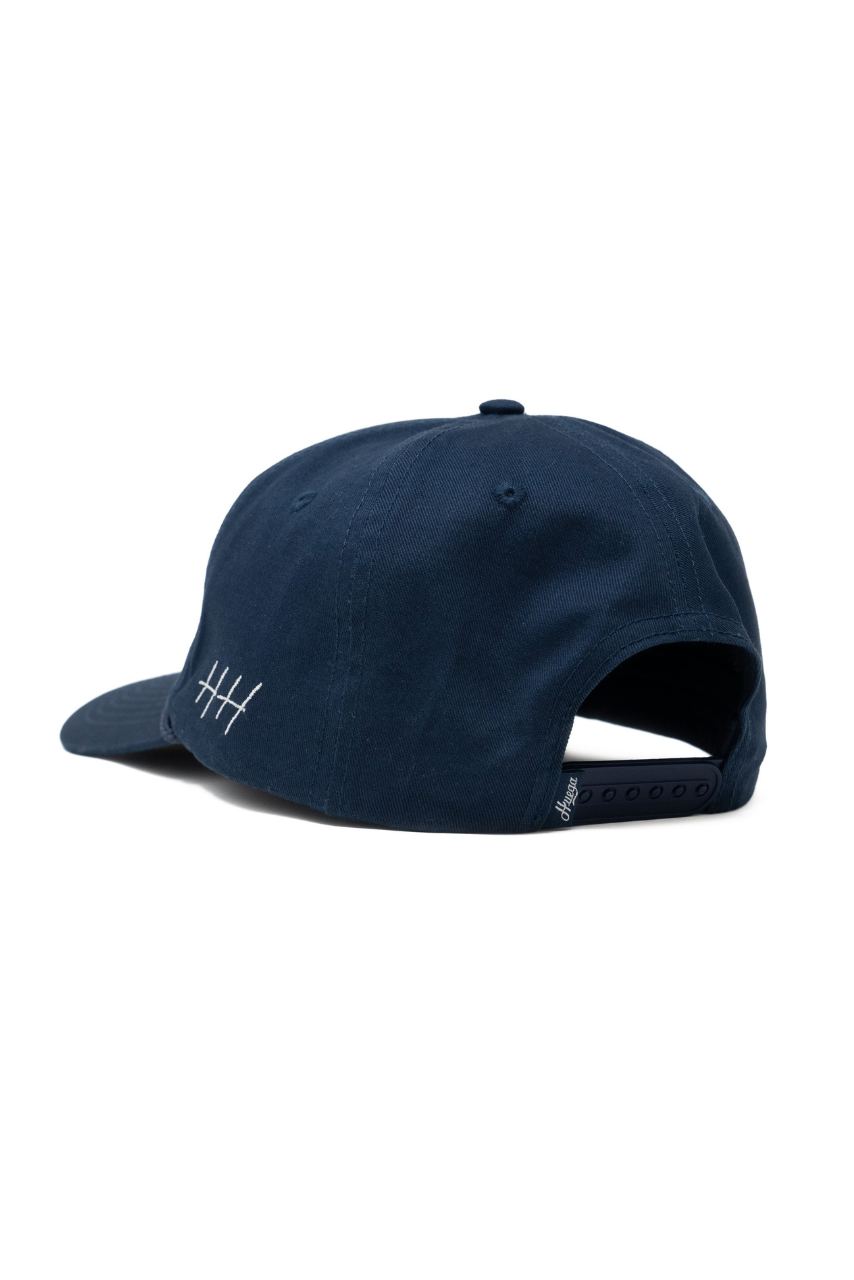 a blue hat with white stitching