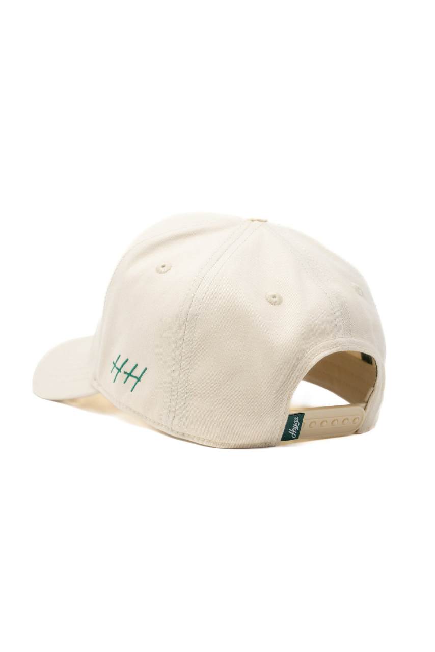a white baseball cap with green text