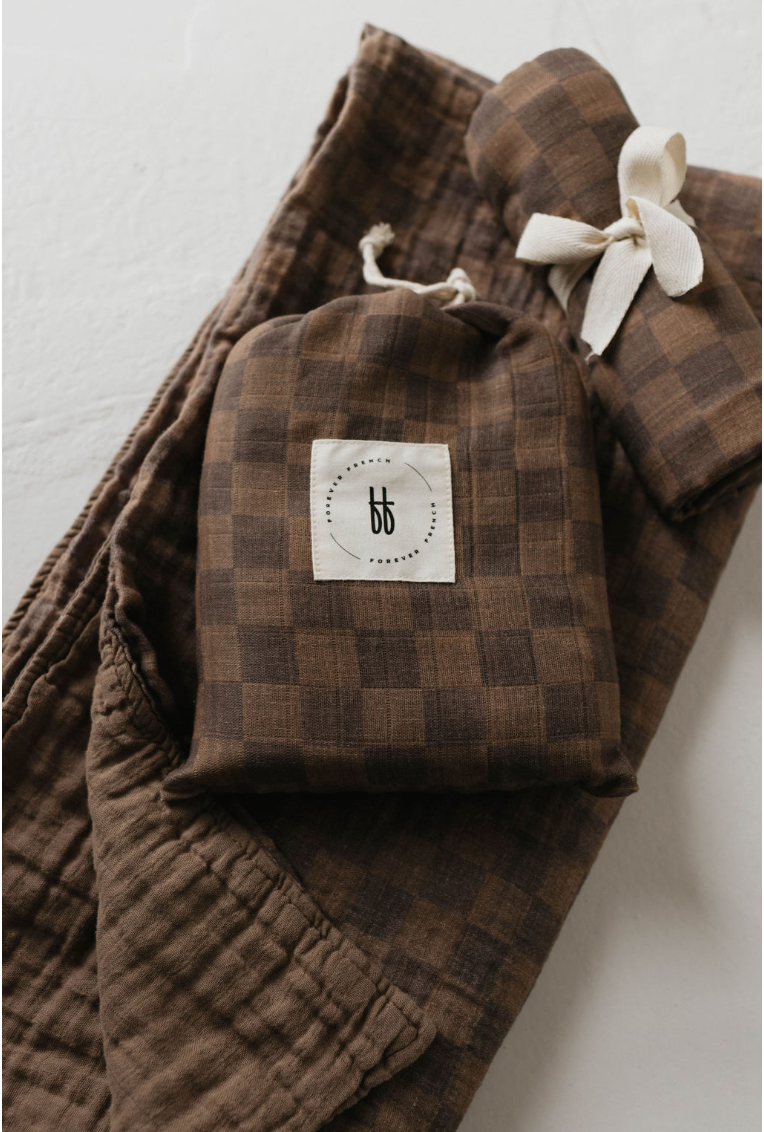 a brown plaid fabric with a white bow