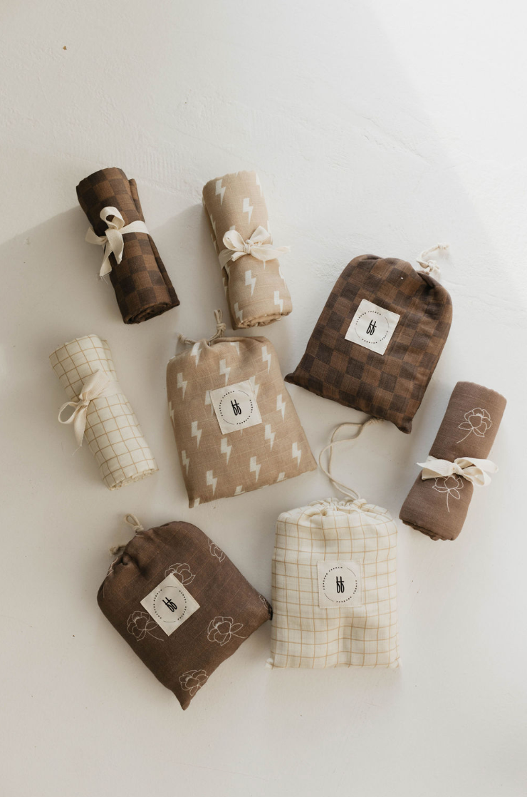 a group of brown and white fabric bags