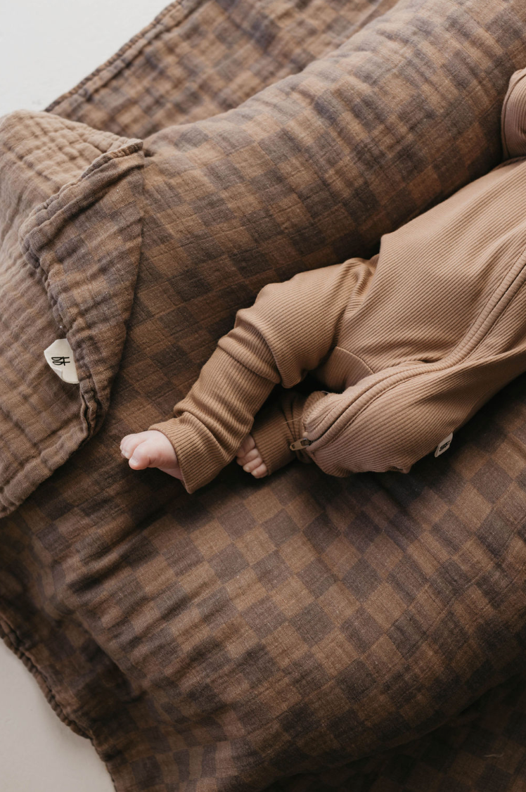 a baby lying on a couch