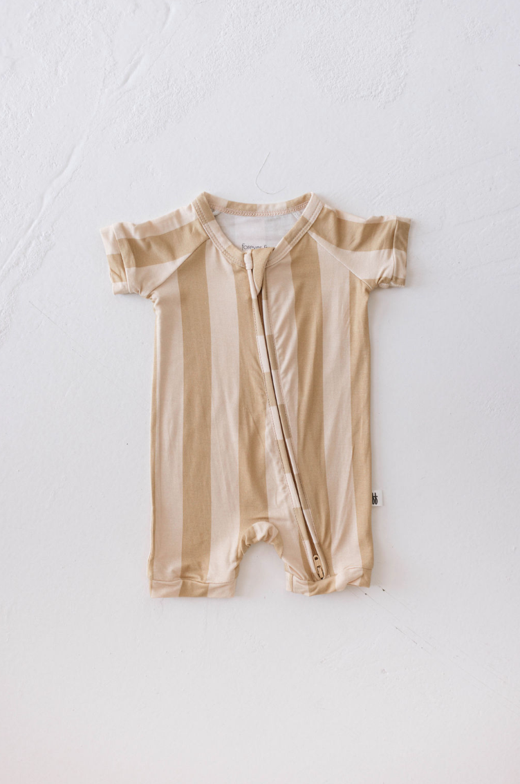 a baby romper on a white surface