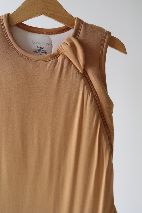 a tan tank top with a knot on it