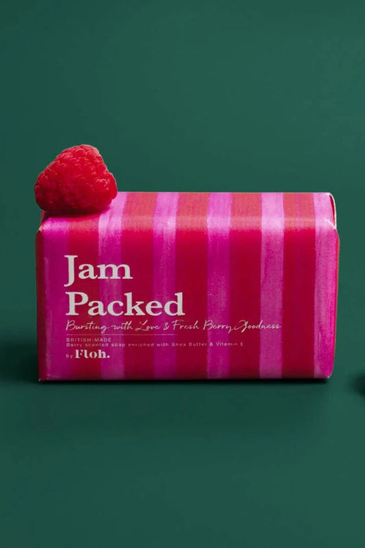 Pink striped soap bar with 'Jam Packed' branding and raspberries on a green background