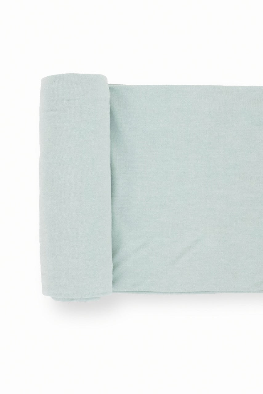 a folded blanket on a white background