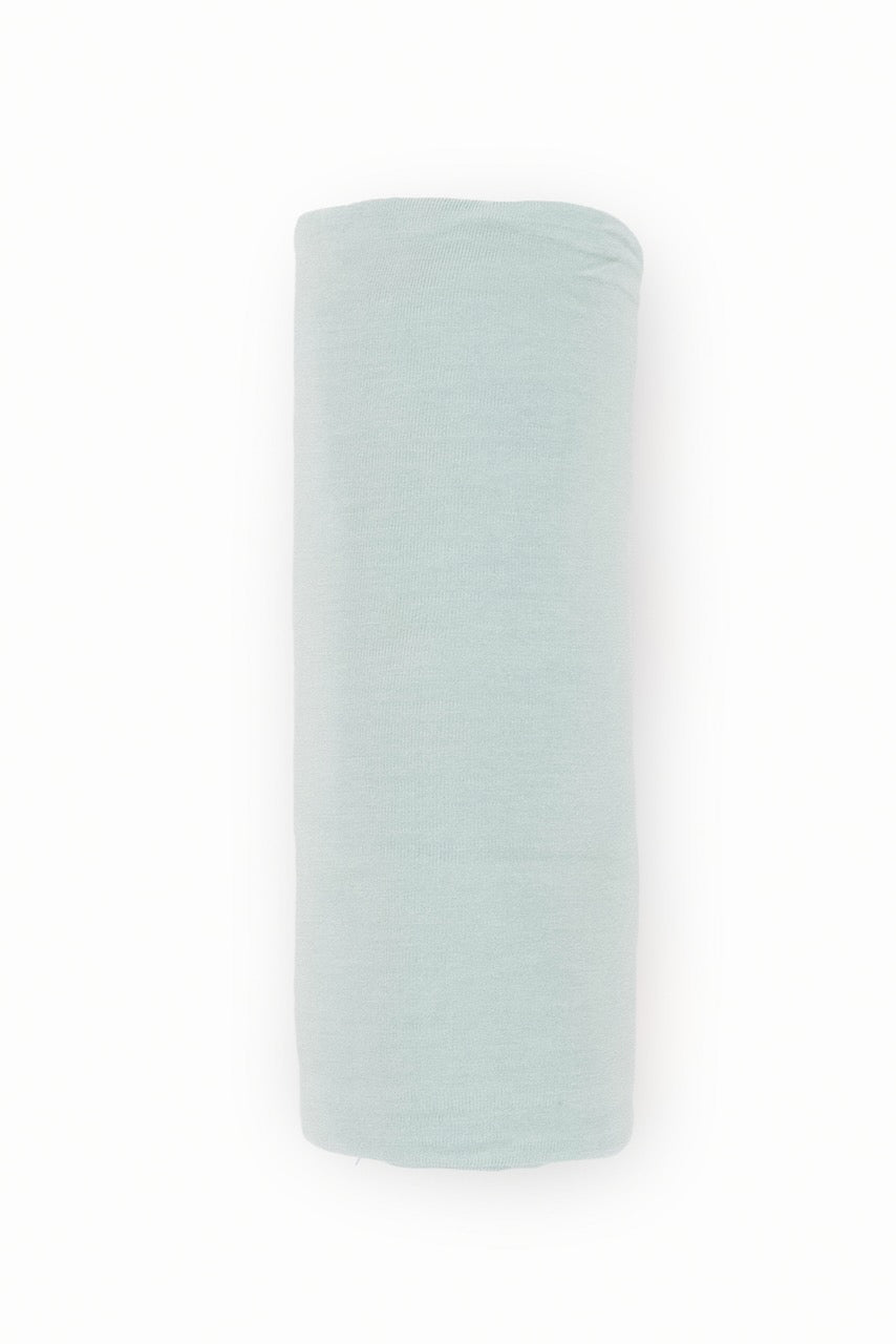 a white rolled up blanket