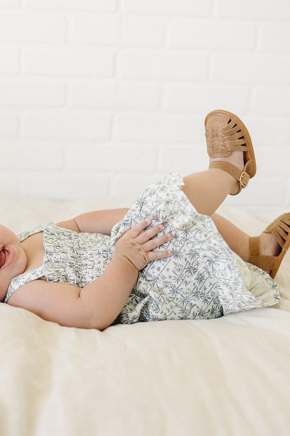 a baby lying on a bed