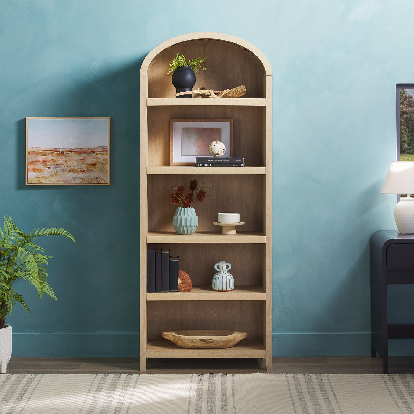 a bookcase with a piano and vases on it