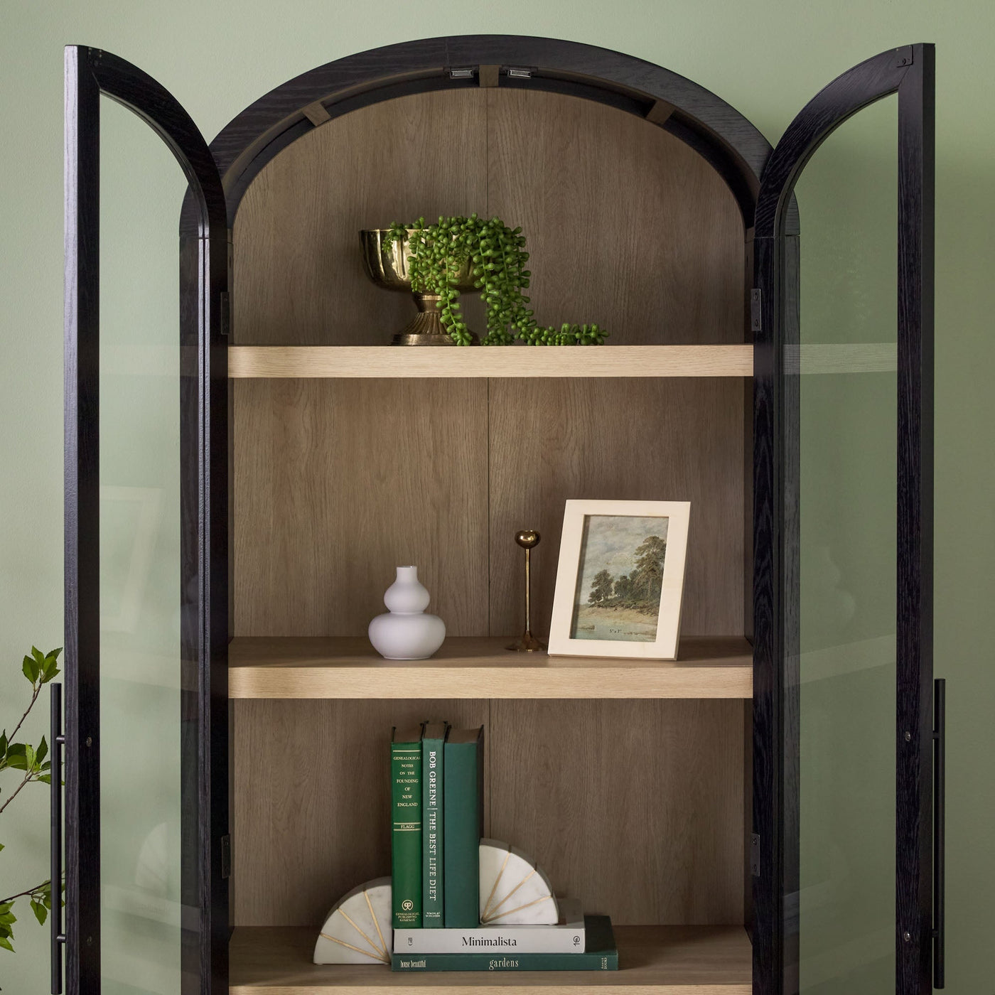 a shelf with books and a picture on it