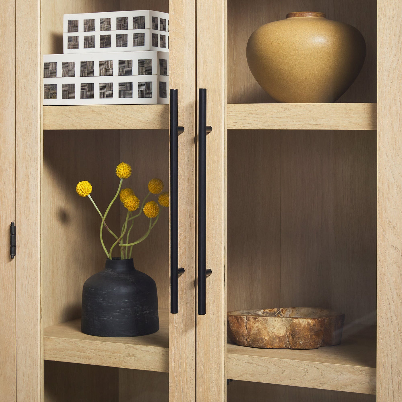 a wood cabinet with shelves and vases