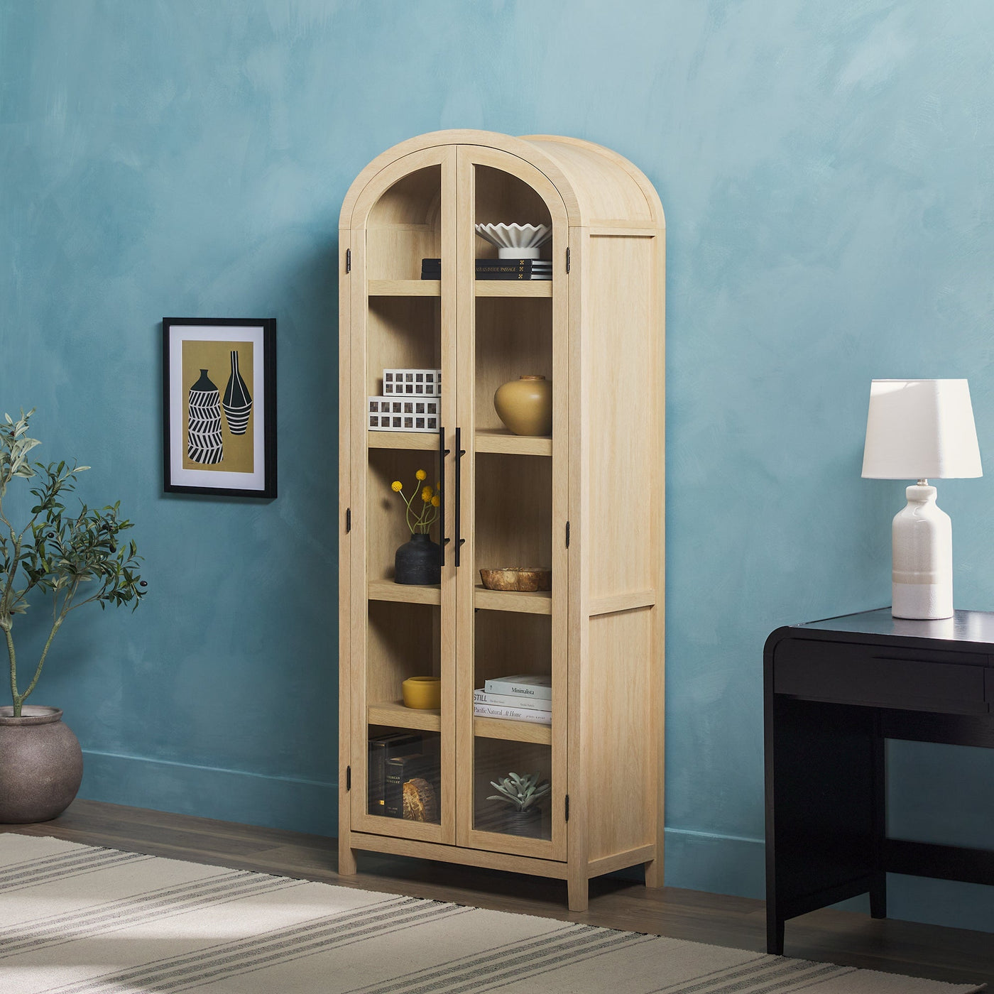 a cabinet with shelves and a lamp in a room