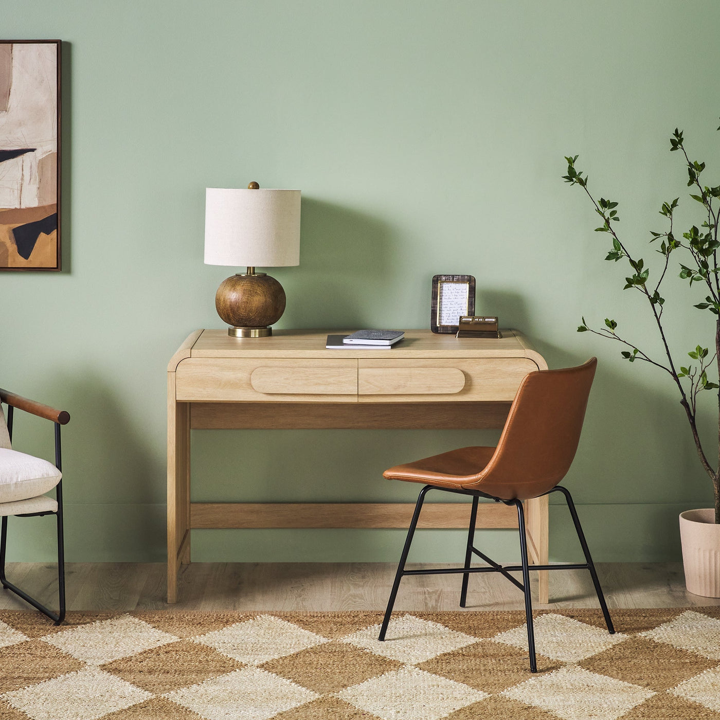 a desk with a chair and a lamp in a room